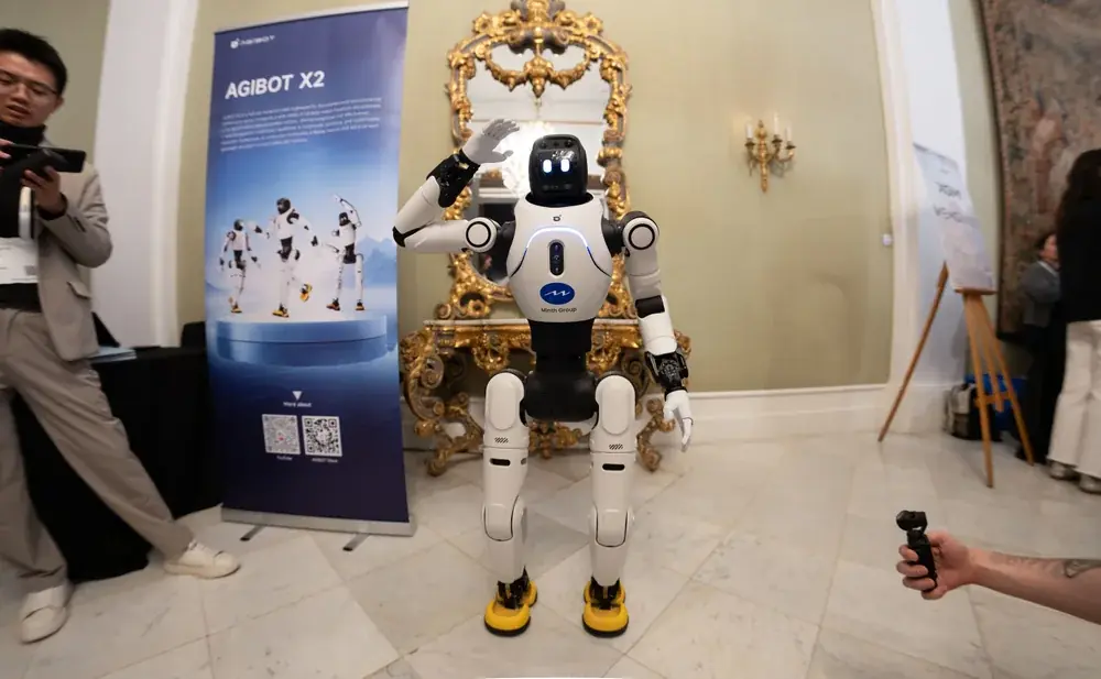 AGIBOT X2 humanoid waving at an MWC 2026 demonstration.