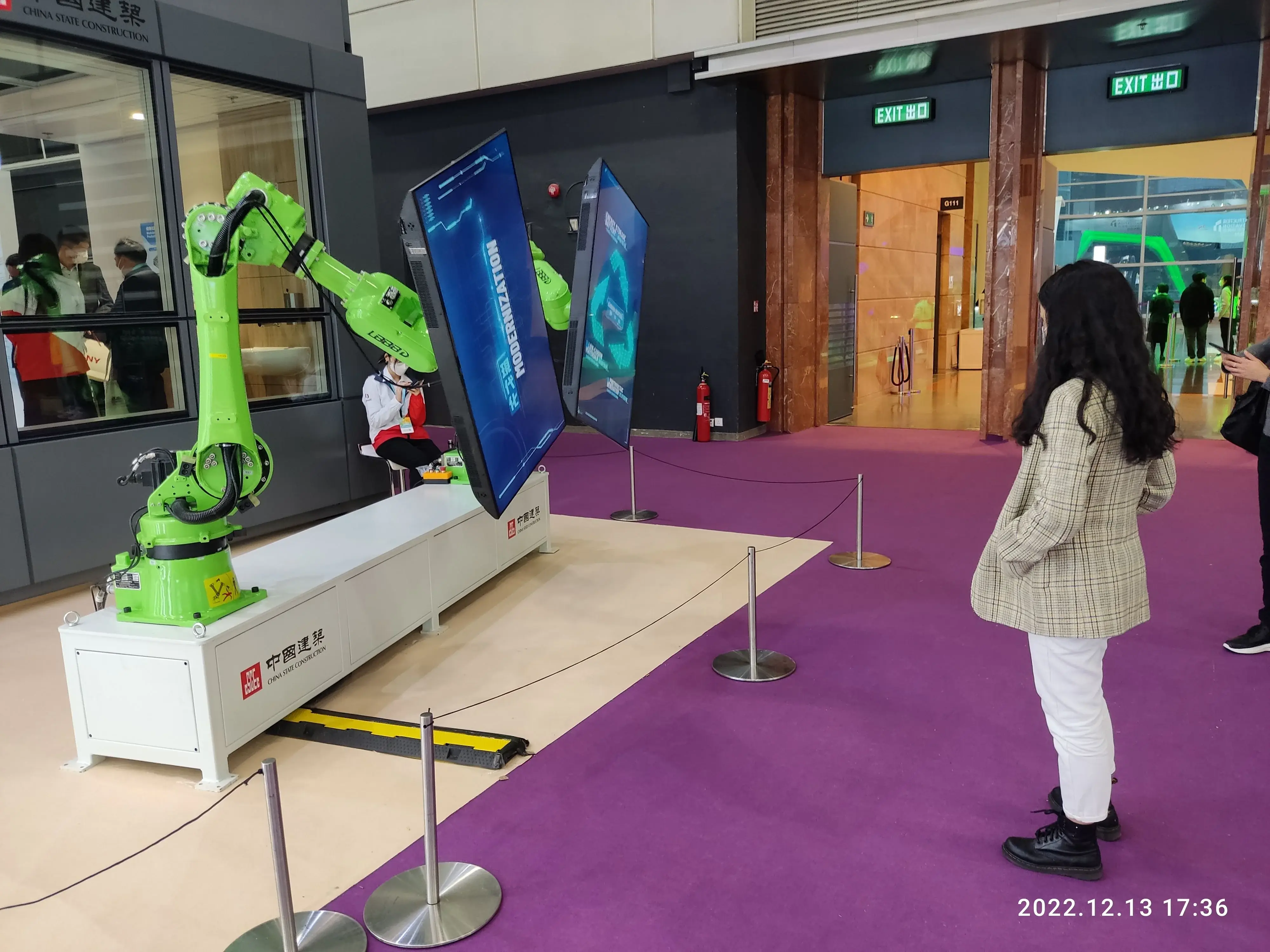 Green industrial robot arms displayed at the 2022 Construction Innovation Expo in Hong Kong.