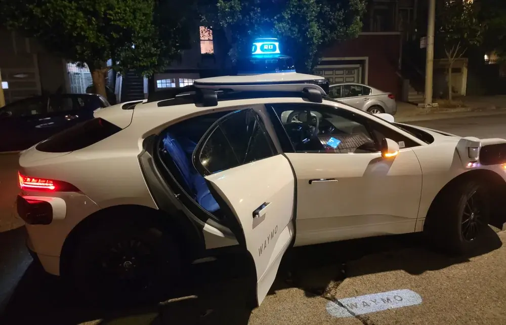 Waymo Jaguar I-Pace robotaxi photographed at night in July 2024.