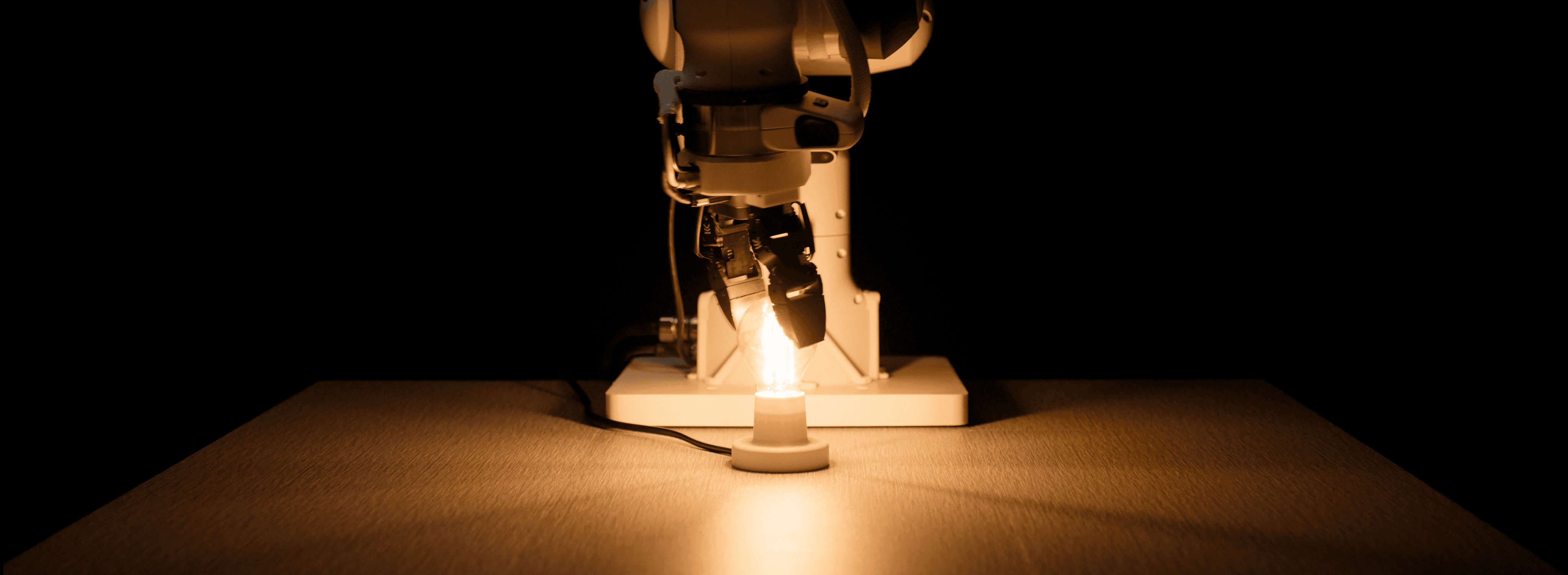 Eka Robotics’ official announcement photograph of a robotic gripper manipulating a lit object.