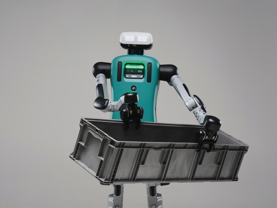 Agility Digit humanoid holding a large gray plastic tote