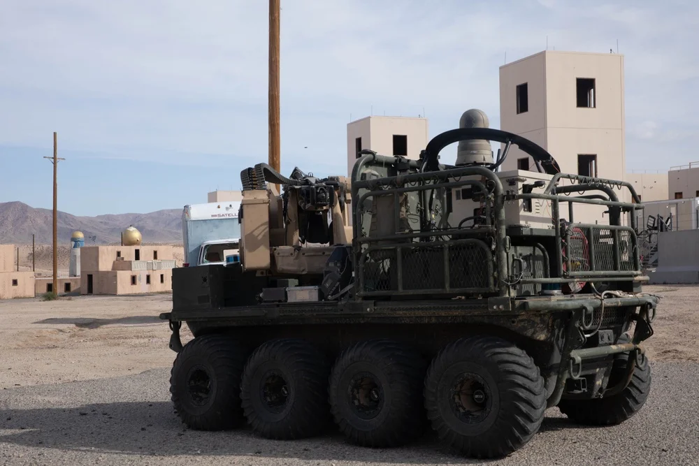 Eight-wheeled Army SMET ground robot in an urban training area at Fort Irwin.
