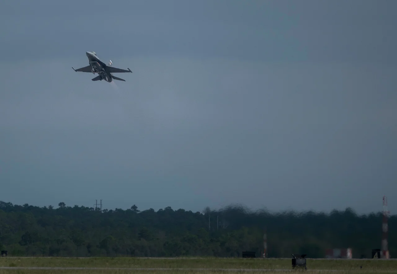 A VENOM-modified F-16 climbs above Eglin Air Force Base during a test flight.